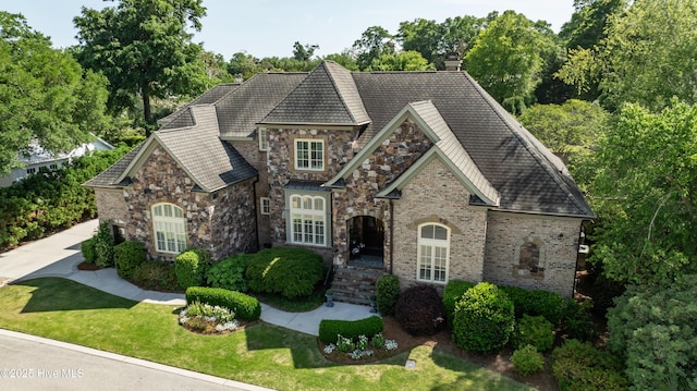 2220 Bel Arbor Pl, Wilmington, NC 28403 - view of front facade featuring a front lawn, stone siding, a chimney, and brick siding