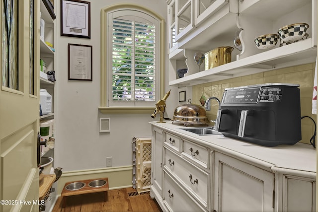 2220 Bel Arbor Pl, Wilmington, NC 28403 - kitchen with light countertops, plenty of natural light, wood finished floors, and open shelves