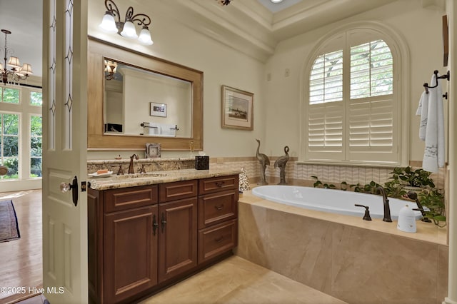 2220 Bel Arbor Pl, Wilmington, NC 28403 - full bathroom featuring healthy amount of natural light, vanity, a garden tub, and a chandelier