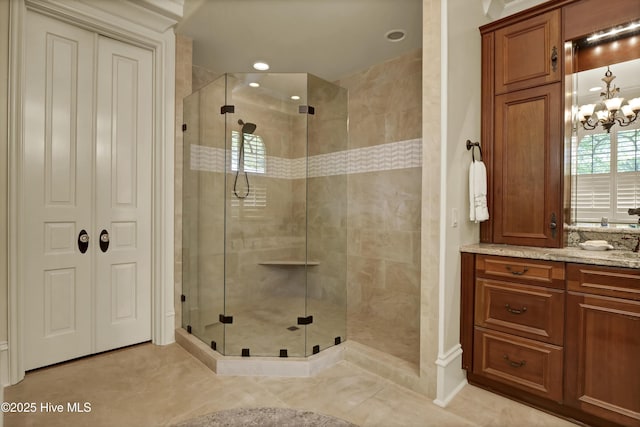 2220 Bel Arbor Pl, Wilmington, NC 28403 - bathroom featuring a stall shower, vanity, and a chandelier
