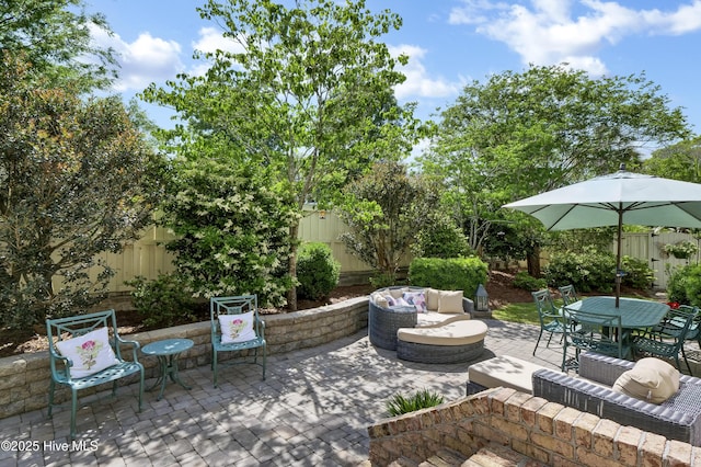 2220 Bel Arbor Pl, Wilmington, NC 28403 - fenced backyard with a patio area, an outdoor hangout area, and outdoor dining space