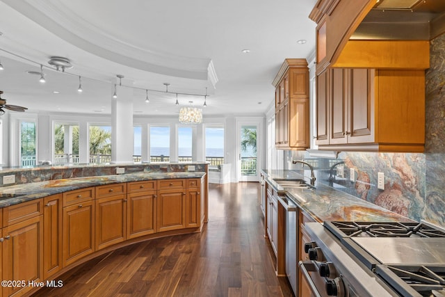 805 S Lumina Ave, Wrightsville Beach, NC 28480 - kitchen featuring a sink, brown cabinetry, stainless steel appliances, and dark wood-style flooring