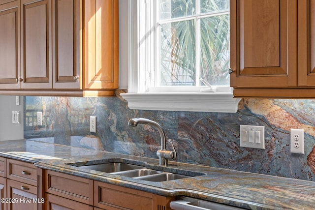 805 S Lumina Ave, Wrightsville Beach, NC 28480 - kitchen with a wealth of natural light, brown cabinets, tasteful backsplash, and a sink