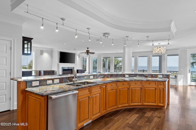805 S Lumina Ave, Wrightsville Beach, NC 28480 - kitchen featuring crown molding, stainless steel dishwasher, open floor plan, and a sink