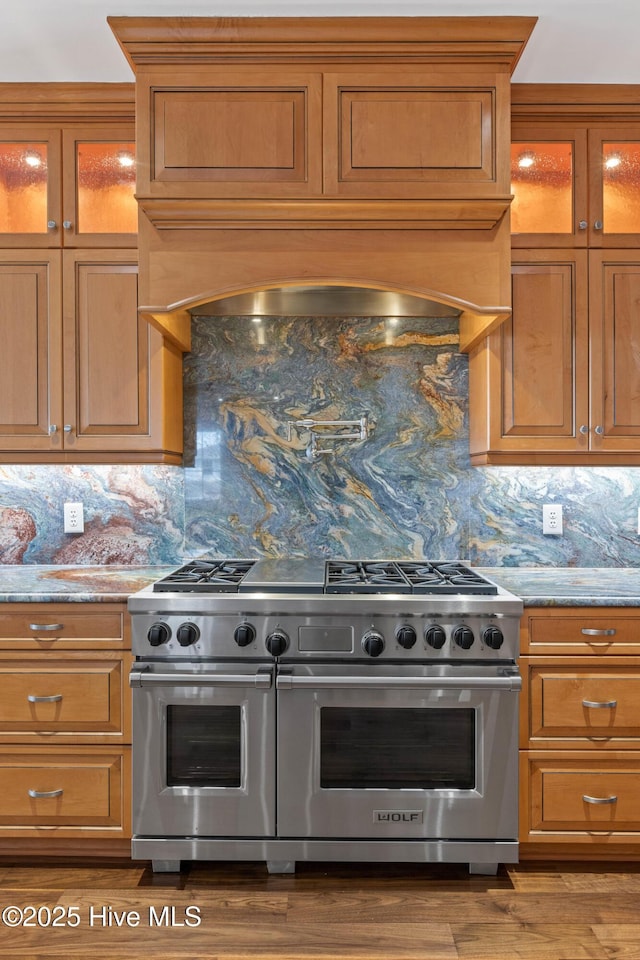 805 S Lumina Ave, Wrightsville Beach, NC 28480 - kitchen featuring light stone countertops, brown cabinetry, and range with two ovens