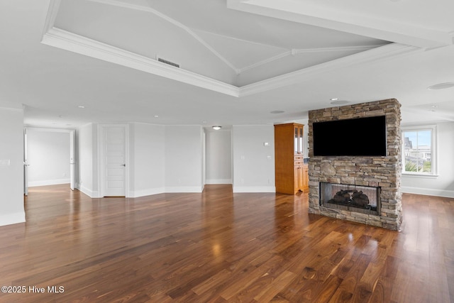 805 S Lumina Ave, Wrightsville Beach, NC 28480 - unfurnished living room featuring a stone fireplace, crown molding, visible vents, and wood finished floors