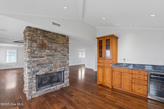 805 S Lumina Ave, Wrightsville Beach, NC 28480 - kitchen with wine cooler, glass insert cabinets, baseboards, visible vents, and vaulted ceiling with beams