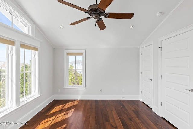 805 S Lumina Ave, Wrightsville Beach, NC 28480 - unfurnished bedroom featuring baseboards, multiple windows, and vaulted ceiling
