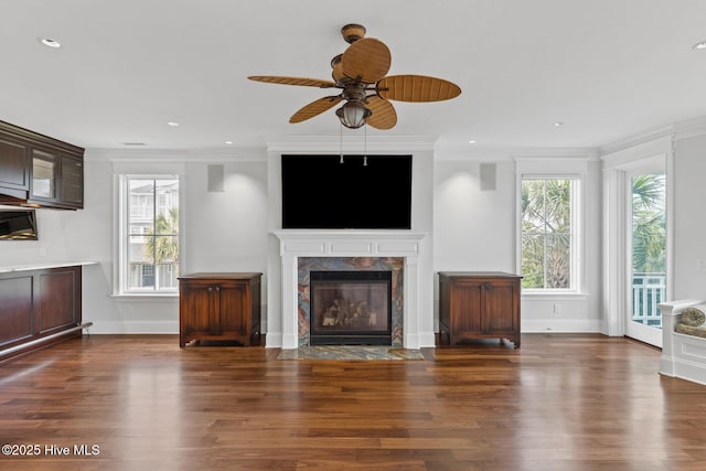805 S Lumina Ave, Wrightsville Beach, NC 28480 - unfurnished living room featuring ceiling fan, wood finished floors, a premium fireplace, and ornamental molding