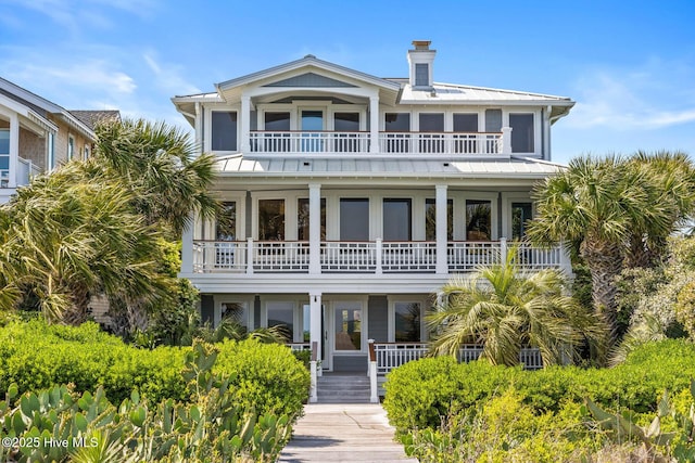 805 S Lumina Ave, Wrightsville Beach, NC 28480 - back of property featuring a chimney and a balcony
