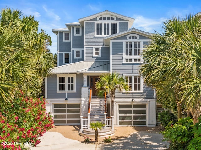 805 S Lumina Ave, Wrightsville Beach, NC 28480 - view of front facade with stairway, a garage, a standing seam roof, and driveway