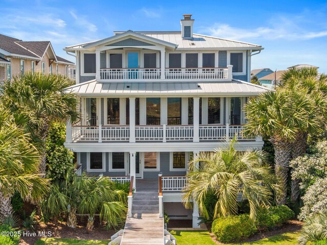 805 S Lumina Ave, Wrightsville Beach, NC 28480 - back of house featuring a chimney, metal roof, a standing seam roof, and a balcony