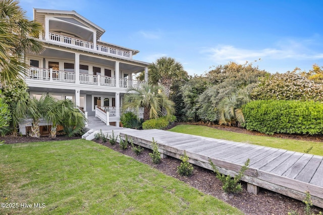 805 S Lumina Ave, Wrightsville Beach, NC 28480 - back of house featuring covered porch, a lawn, and a balcony