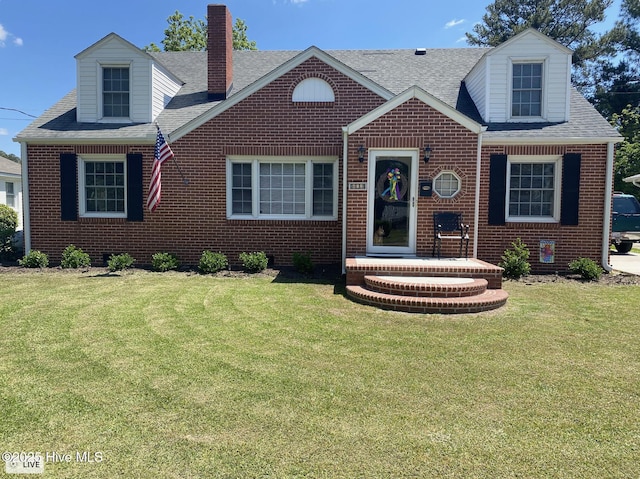 612 Blaney St, Clinton, NC 28328 - cape cod-style house with brick siding, a chimney, and a front lawn