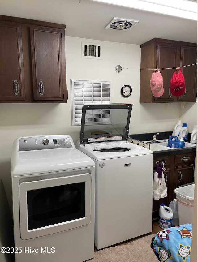 612 Blaney St, Clinton, NC 28328 - washroom with visible vents, cabinet space, carpet floors, and separate washer and dryer