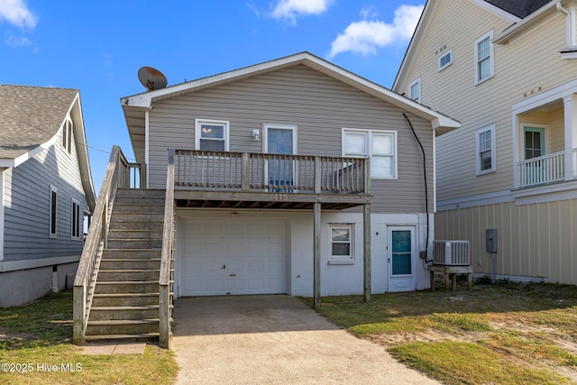 415 W Boardwalk Blvd, Atlantic Beach, NC 28512 - back of house featuring stairway, concrete driveway, an attached garage, and central AC unit