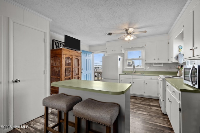 415 W Boardwalk Blvd, Atlantic Beach, NC 28512 - kitchen with white appliances, a sink, a ceiling fan, a textured ceiling, and white cabinets