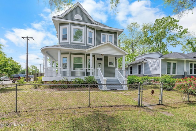 victorian home with a porch, a gate, a front lawn, and a fenced front yard