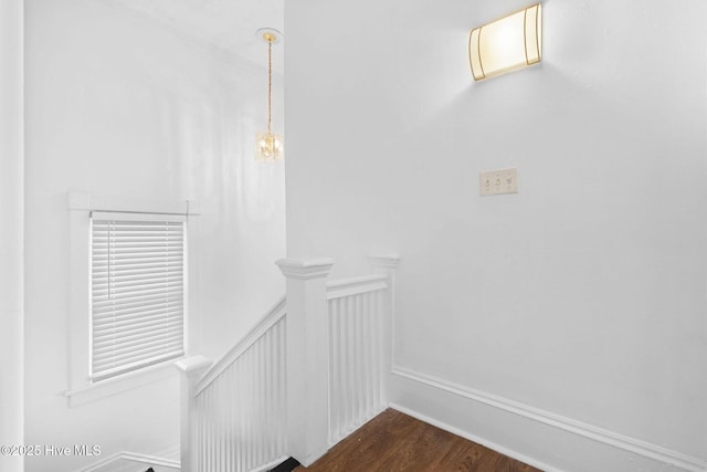 stairway featuring baseboards and wood finished floors