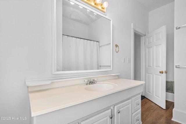 full bathroom featuring visible vents, wood finished floors, and vanity