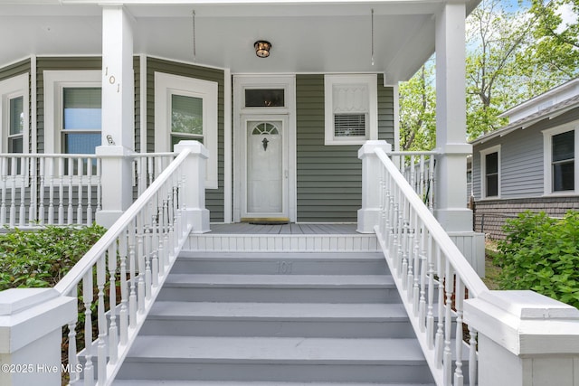 view of exterior entry with a porch