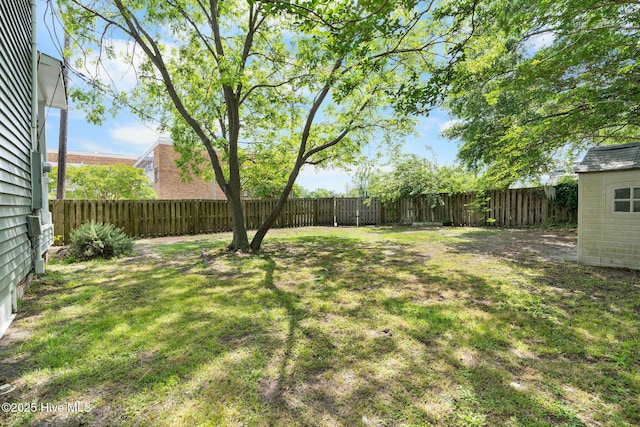 view of yard with an outdoor structure and a fenced backyard