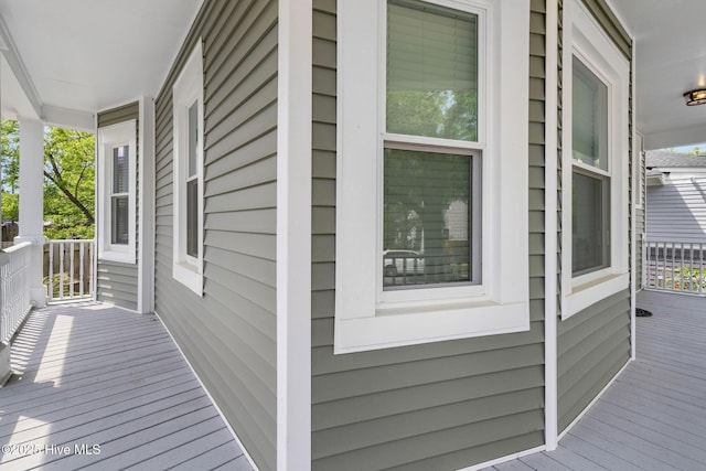 view of side of home with covered porch