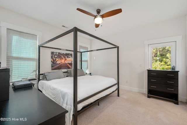 bedroom with light colored carpet, baseboards, ceiling fan, and visible vents