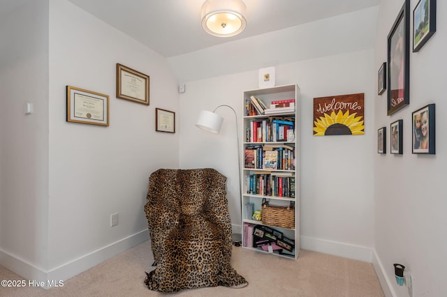 living area with carpet floors, baseboards, and vaulted ceiling