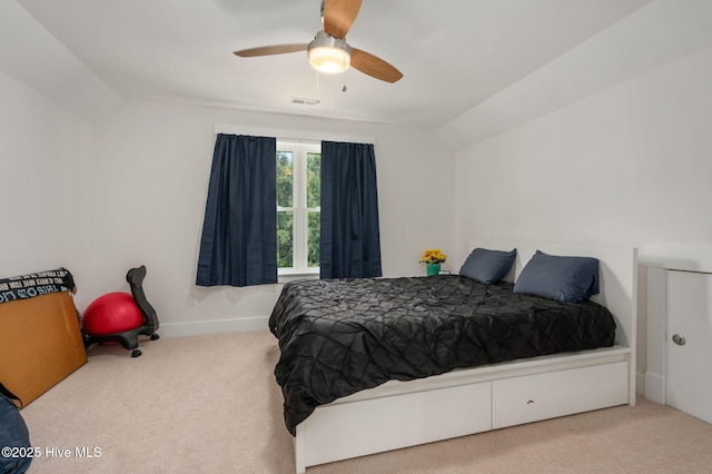 carpeted bedroom featuring visible vents, a ceiling fan, baseboards, and vaulted ceiling