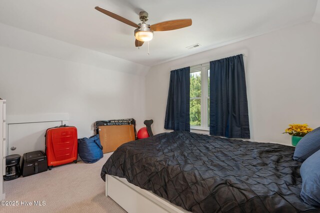 carpeted bedroom with ceiling fan and visible vents