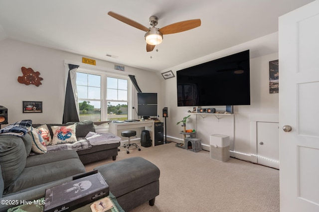 carpeted living area with baseboards, a ceiling fan, and visible vents