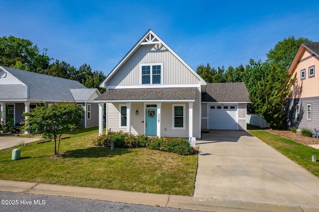 view of front facade with a garage, a front lawn, board and batten siding, a porch, and driveway