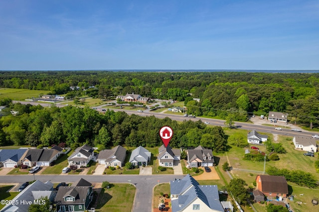 drone / aerial view with a residential view and a view of trees