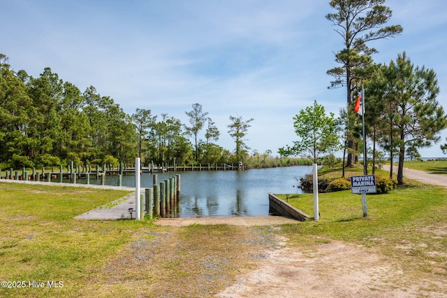 dock area with a yard and a water view
