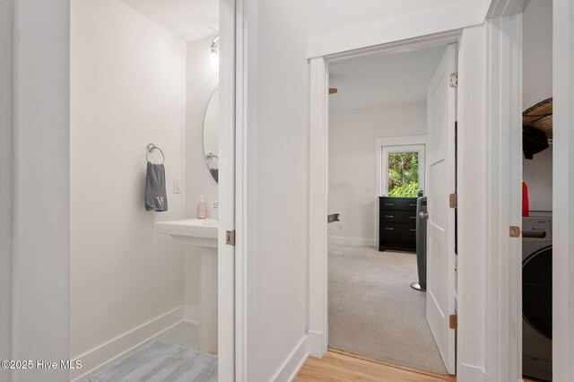 bathroom with baseboards and washer / dryer
