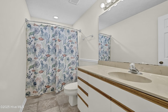 bathroom with toilet, a shower with curtain, visible vents, and vanity