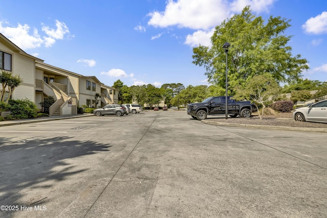 uncovered parking lot featuring a residential view