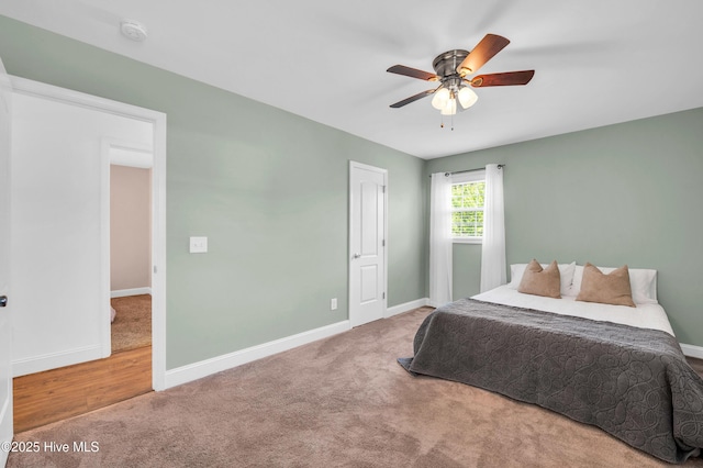 carpeted bedroom featuring baseboards and ceiling fan