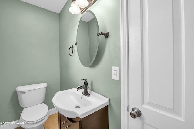 bathroom featuring tile patterned floors, vanity, and toilet