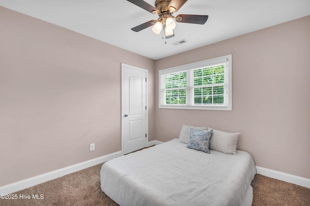 bedroom with baseboards, ceiling fan, carpet, and visible vents