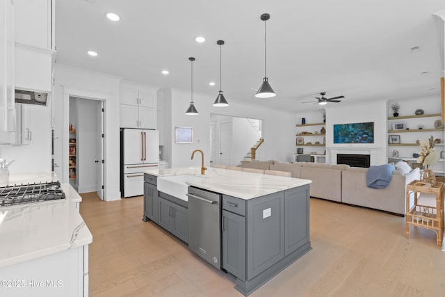 kitchen featuring high end white fridge, a sink, gray cabinets, a ceiling fan, and stainless steel dishwasher