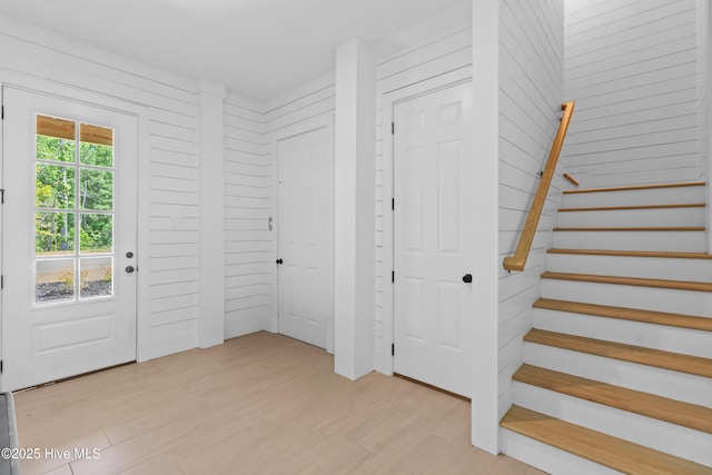 entrance foyer with light wood finished floors and stairway