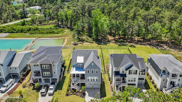 drone / aerial view with a water view and a residential view