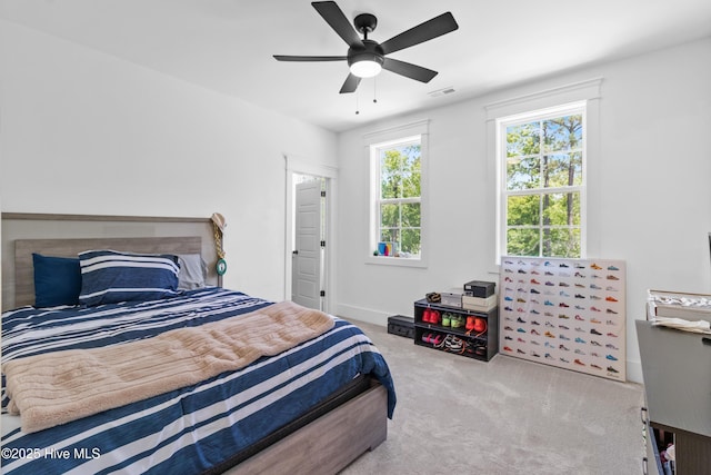 bedroom with visible vents, a ceiling fan, and carpet floors