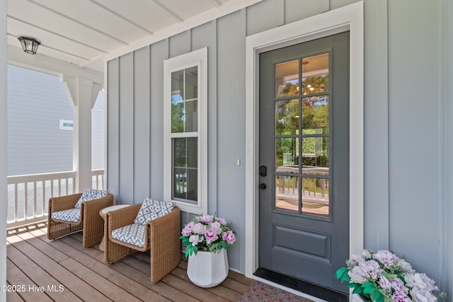 property entrance featuring board and batten siding and a porch