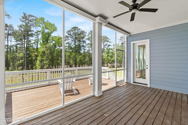 unfurnished sunroom with ceiling fan