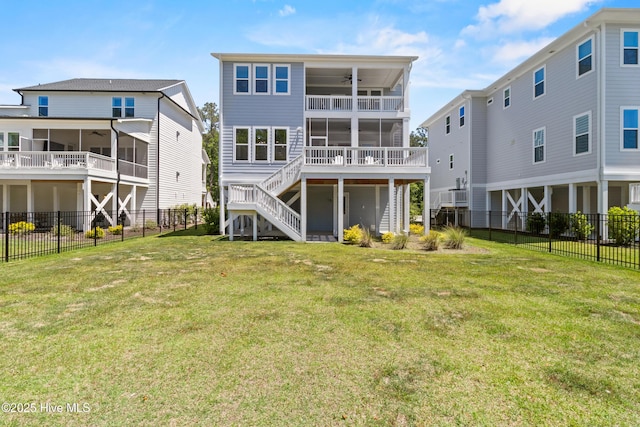 back of property with stairway, a ceiling fan, a fenced backyard, and a sunroom