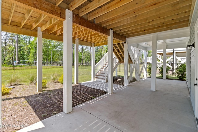 view of patio / terrace featuring fence and stairs