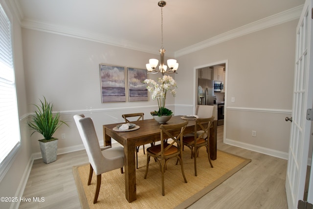 218 Country Club Dr SW, Shallotte, NC 28470 - dining room featuring a chandelier, plenty of natural light, and light wood-style flooring
